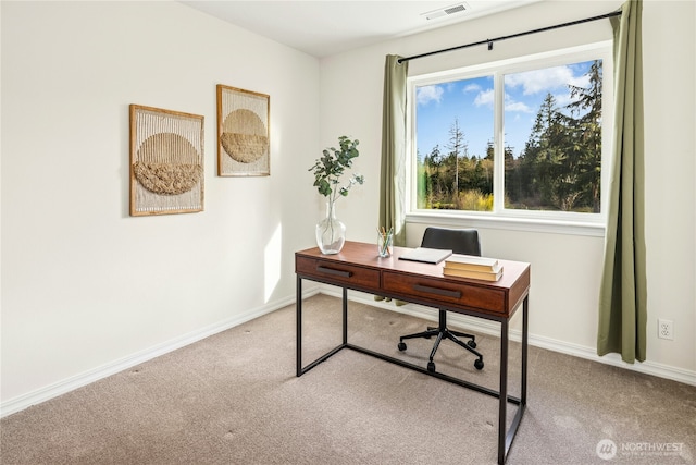 carpeted office space with baseboards and visible vents