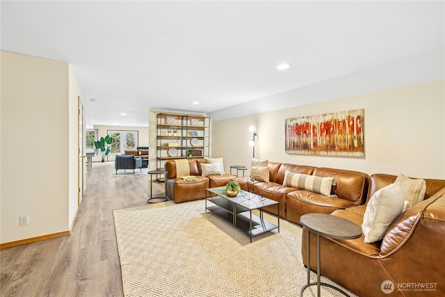 living area featuring light wood-style flooring, baseboards, and recessed lighting