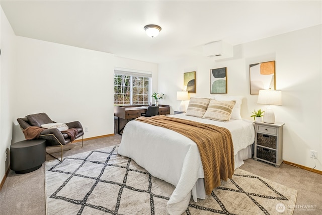 bedroom with baseboards and light colored carpet