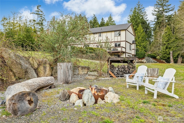 view of yard featuring an outdoor fire pit and a wooden deck