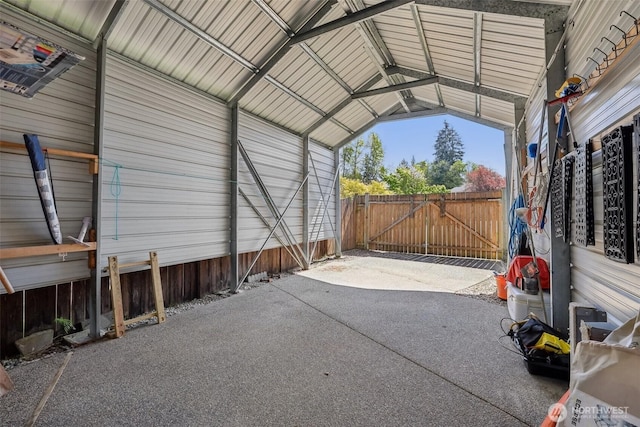 view of car parking with a detached carport and a gate