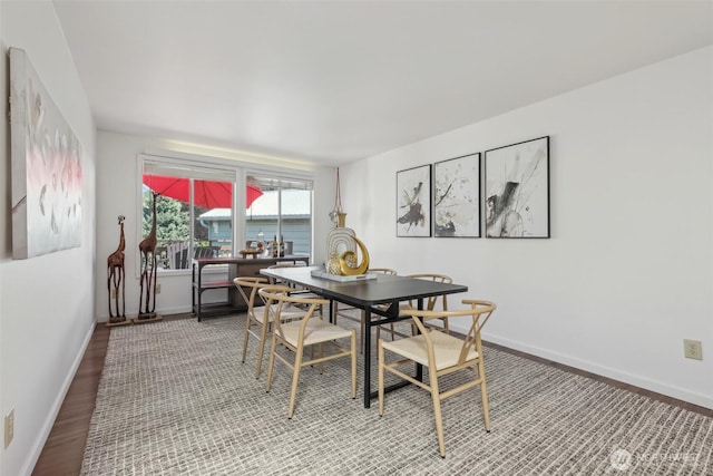 dining area with light wood finished floors and baseboards
