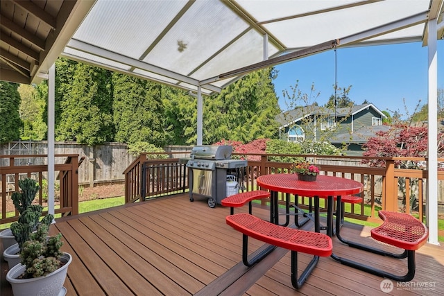 wooden deck featuring fence, outdoor dining space, and grilling area