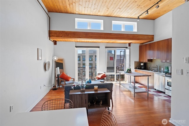 1408 12th Ave Unit 507, Seattle, WA 98122 - living area with wooden ceiling, plenty of natural light, rail lighting, wood finished floors, and a high ceiling