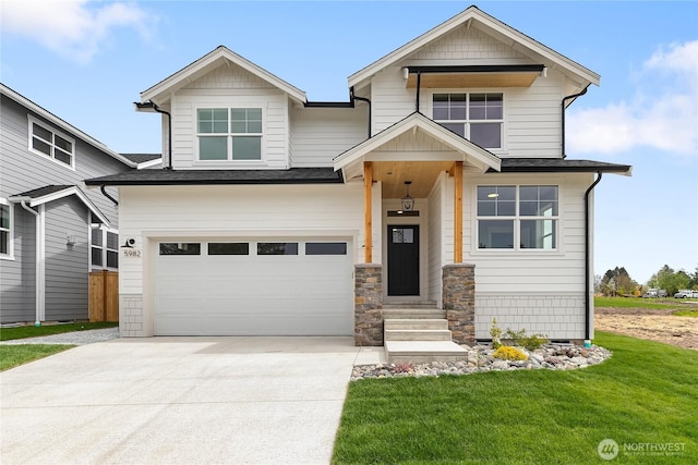 craftsman-style home with an attached garage, driveway, and a front lawn