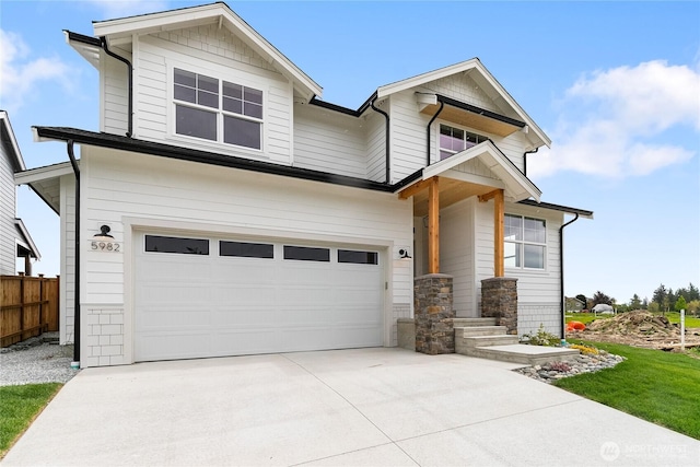 craftsman inspired home with concrete driveway, an attached garage, and fence