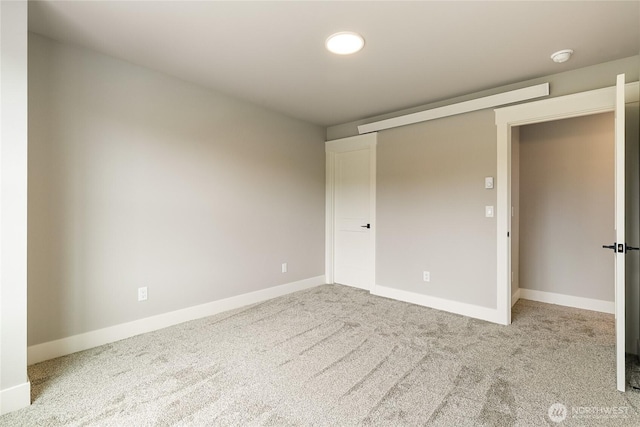 unfurnished bedroom featuring carpet floors and baseboards