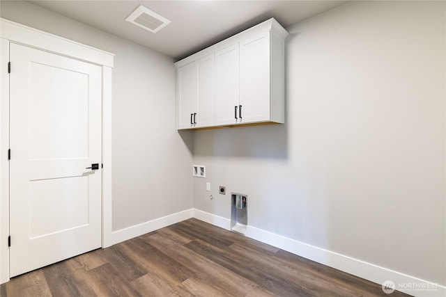 laundry area featuring visible vents, baseboards, cabinet space, and dark wood-style flooring