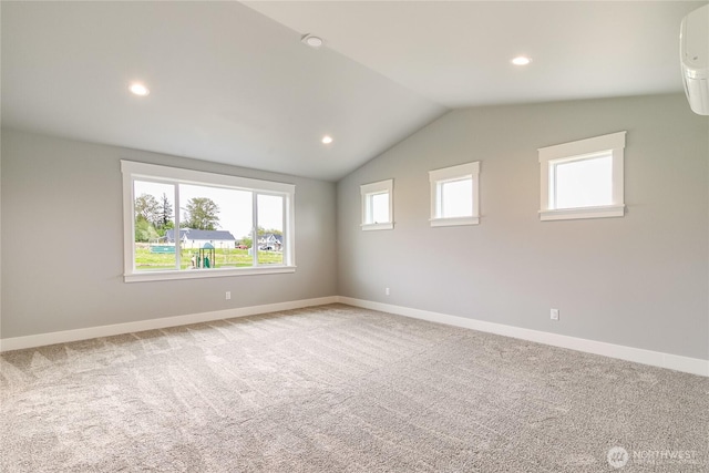 carpeted spare room featuring baseboards, vaulted ceiling, recessed lighting, and an AC wall unit