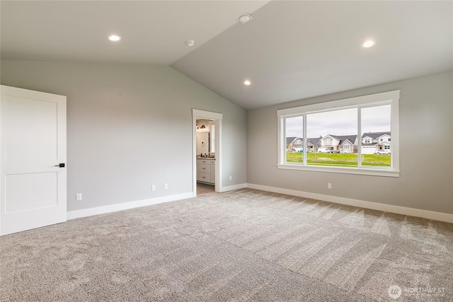 unfurnished bedroom featuring light colored carpet, recessed lighting, baseboards, and vaulted ceiling