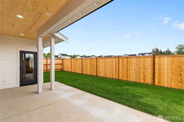 view of yard featuring a patio and a fenced backyard