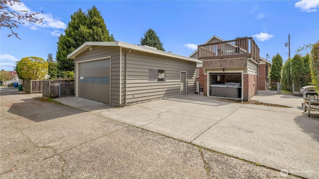 detached garage featuring fence
