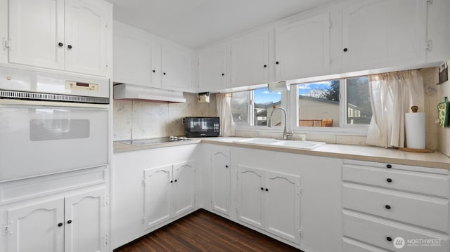 3212 S 182nd Pl Unit 193, Seatac, WA 98188 - kitchen featuring white cabinets, under cabinet range hood, a sink, and black appliances