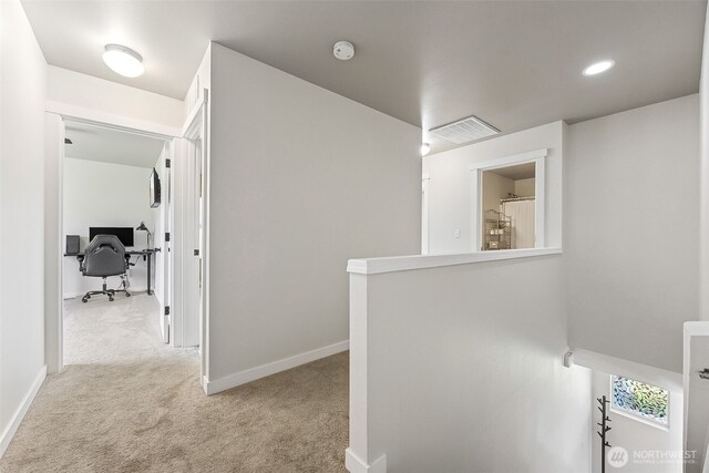 hallway featuring visible vents, baseboards, an upstairs landing, carpet, and recessed lighting