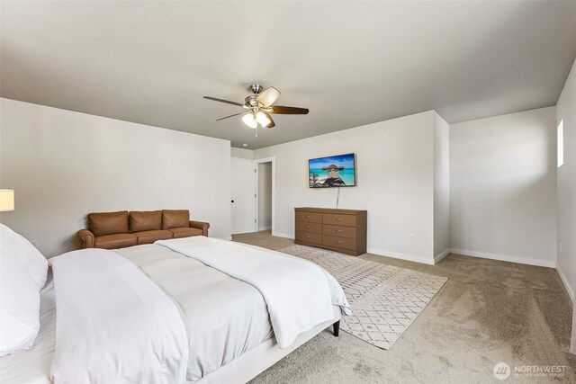 carpeted bedroom featuring baseboards and ceiling fan
