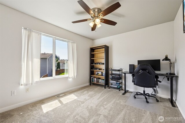home office with baseboards, ceiling fan, carpet, and visible vents