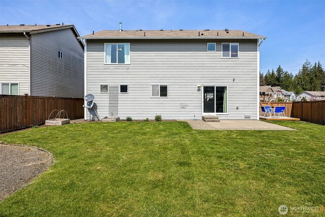 rear view of house featuring a patio, a fenced backyard, and a yard
