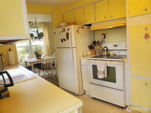 kitchen with light floors, white appliances, light countertops, and under cabinet range hood