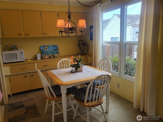 dining room featuring a wealth of natural light and a chandelier