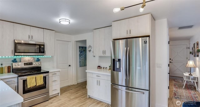 kitchen featuring light countertops, visible vents, and appliances with stainless steel finishes