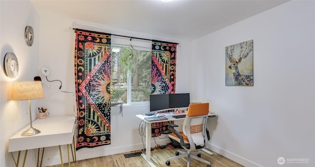 home office with baseboards and wood finished floors