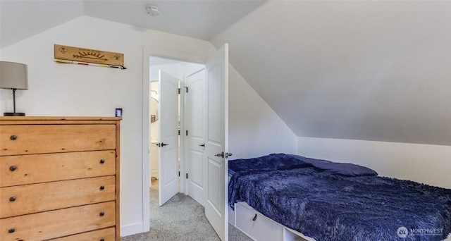 carpeted bedroom with vaulted ceiling