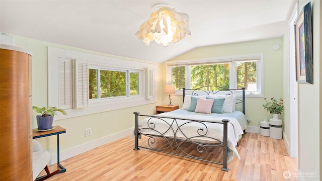 4657 Island Ave NE, Bainbridge Island, WA 98110 - bedroom with multiple windows, wood finished floors, lofted ceiling, and baseboards