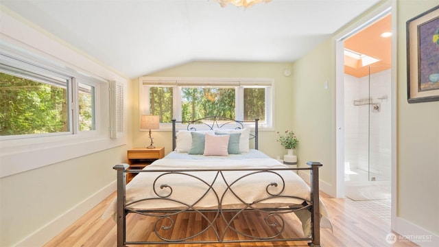 4657 Island Ave NE, Bainbridge Island, WA 98110 - bedroom featuring vaulted ceiling, light wood finished floors, baseboards, and ensuite bath
