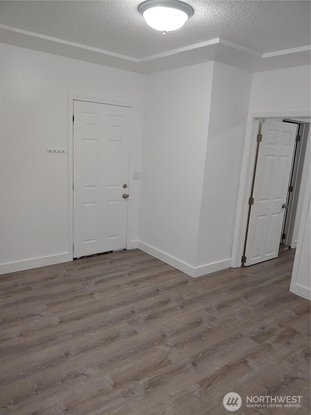 1700 California Ave S, Long Beach, WA 98631 - spare room with a textured ceiling, baseboards, and wood finished floors