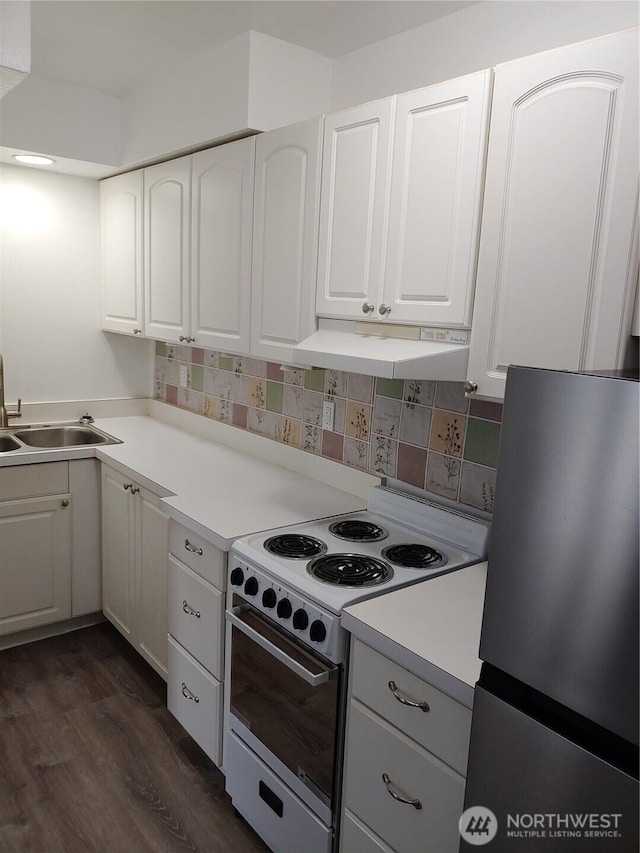 1700 California Ave S, Long Beach, WA 98631 - kitchen featuring white electric range, freestanding refrigerator, white cabinets, under cabinet range hood, and a sink