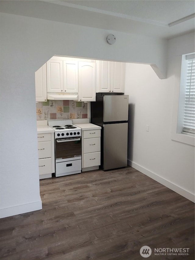 1700 California Ave S, Long Beach, WA 98631 - kitchen featuring baseboards, white range with electric cooktop, freestanding refrigerator, under cabinet range hood, and white cabinetry