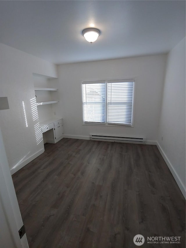 1700 California Ave S, Long Beach, WA 98631 - interior space featuring a baseboard radiator, baseboards, and dark wood finished floors