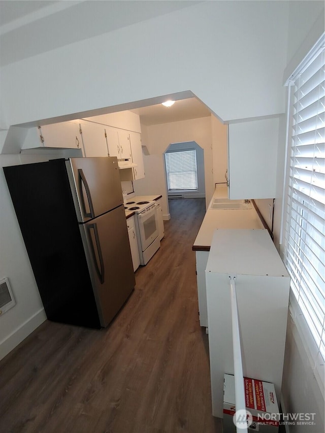 1700 California Ave S, Long Beach, WA 98631 - kitchen with dark wood-style flooring, white cabinetry, freestanding refrigerator, electric range, and a sink