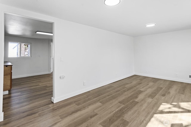 unfurnished room with wood finished floors and baseboards