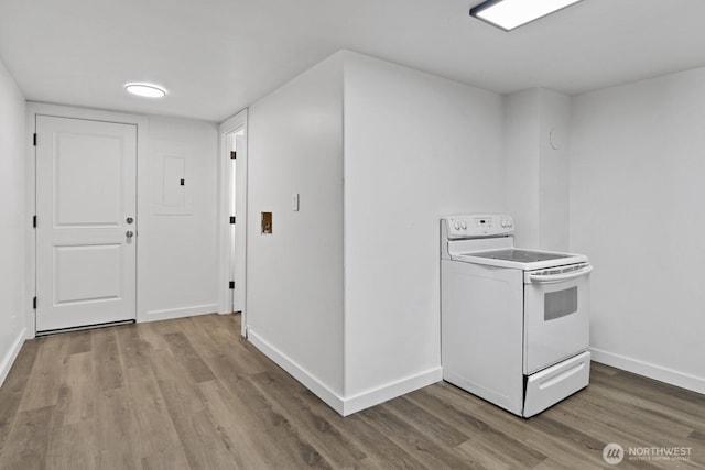 kitchen with baseboards, white electric stove, and wood finished floors