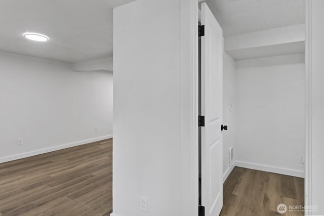 interior space with wood finished floors and baseboards