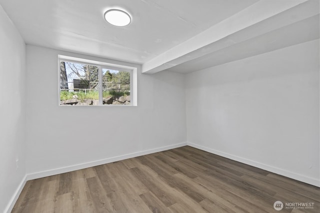 interior space featuring baseboards and wood finished floors