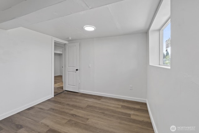 interior space featuring wood finished floors and baseboards