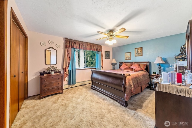 bedroom with a closet, a baseboard radiator, a ceiling fan, and light colored carpet