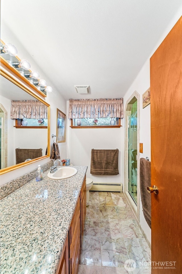 full bath with vanity, a baseboard heating unit, a shower stall, visible vents, and marble finish floor