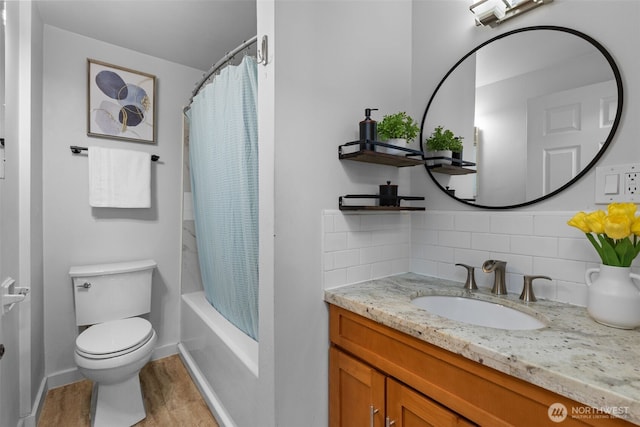 1210 108th Ave SE, Bellevue, WA 98004 - bathroom featuring tasteful backsplash, toilet, shower / bathtub combination with curtain, vanity, and wood finished floors