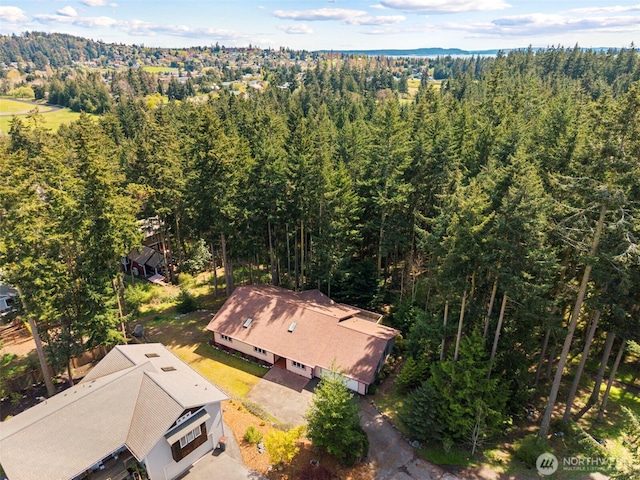 aerial view of property and surrounding area with a forest