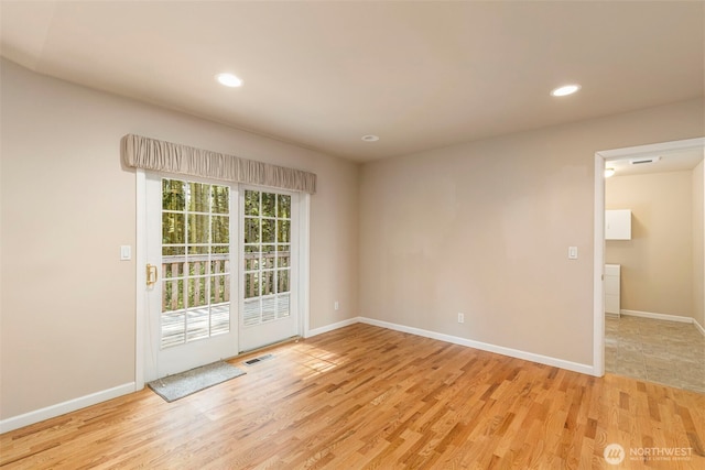 unfurnished room with light wood-style flooring, baseboards, and recessed lighting