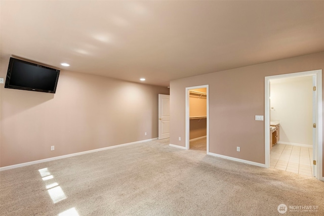below grade area with light colored carpet, recessed lighting, and baseboards