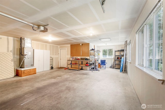 garage with a garage door opener and heating unit