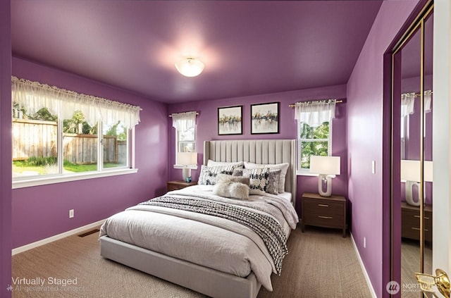 carpeted bedroom with baseboards