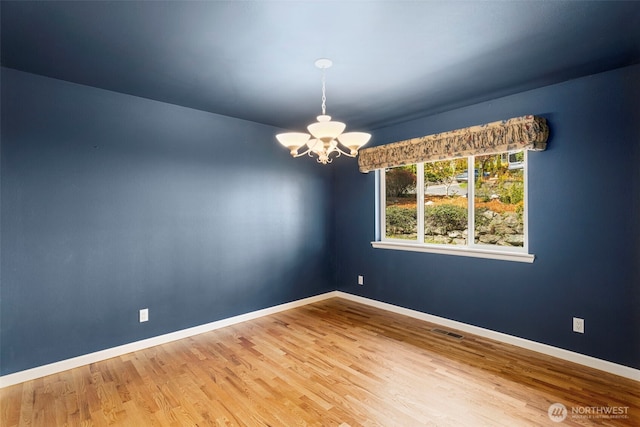 3912 Holcomb Prt, Townsend, WA 98368 - empty room with a chandelier, wood finished floors, and baseboards