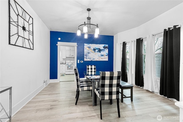 819 NW 50th St, Seattle, WA 98107 - dining area featuring light wood-style flooring, an inviting chandelier, and baseboards