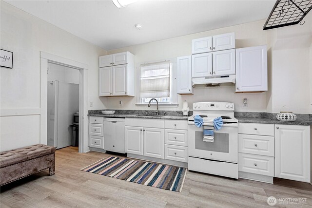 819 NW 50th St, Seattle, WA 98107 - kitchen featuring white appliances, light wood-style flooring, white cabinetry, under cabinet range hood, and a sink
