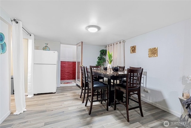 819 NW 50th St, Seattle, WA 98107 - dining area featuring light wood-type flooring and baseboards